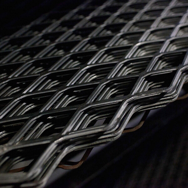 Several pieces of flattened expanded metal in the workshop.